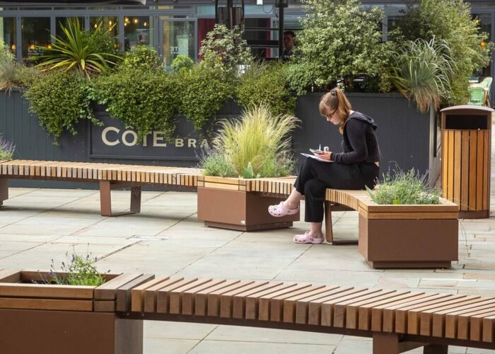Lady-sitting-on-Rilroad-bench-on-her-phone-at-bristol-quaker-friars-2-1024x683 (1)
